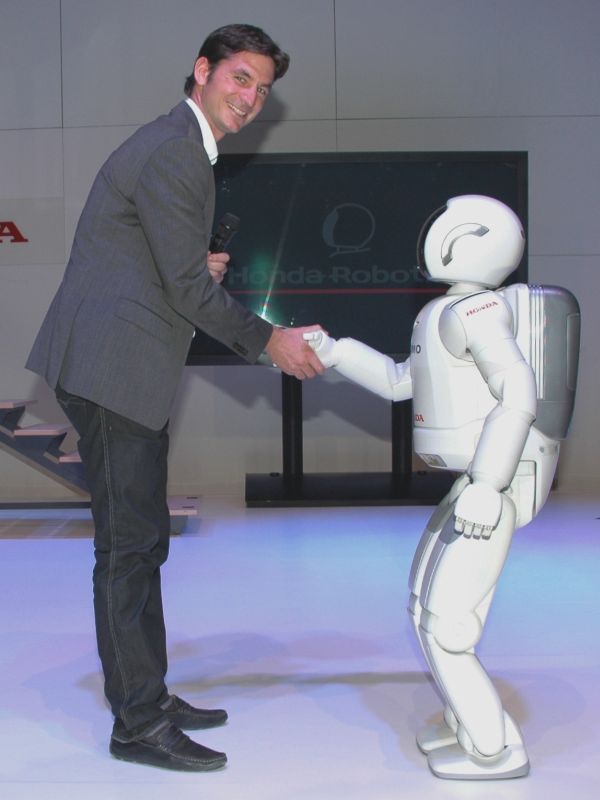 ASIMO shaking hands with guest